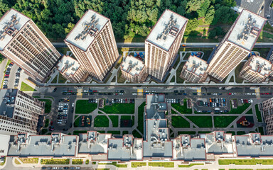 apartment building complex near city park. courtyard with parked cars. aerial drone photo looking...