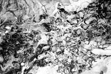 black and white paint spilled onto the canvas, creating an interesting abstract pattern, a pattern of lines, halftones, evoking different associations in your design. liquid art