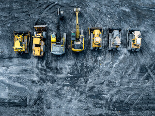 Aerial View of Coal Excavation Site with Multiple Heavy industry Vehicles. © Curioso.Photography