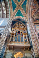 Orvieto, Italy - July 3, 2021: Interior view of city Cathedral with frescoes and paintings