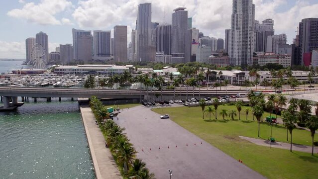 Aerial Shot Of Skyviews Miami By Harbor In City, Drone Ascending Over Trees In Parking Lot