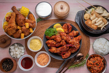 Gang Jeong chicken or crispy and tender Korean fried chicken smothered in a sticky, spicy red sauce Served with kimchi, dipping sauce, rice and sweet corn.