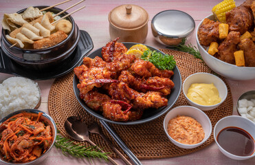 Gang Jeong chicken or crispy and tender Korean fried chicken smothered in a sticky, spicy red sauce Served with kimchi, dipping sauce, rice and sweet corn.