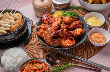 Gang Jeong chicken or crispy and tender Korean fried chicken smothered in a sticky, spicy red sauce Served with kimchi, dipping sauce, rice and sweet corn.