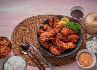 Gang Jeong chicken or crispy and tender Korean fried chicken smothered in a sticky, spicy red sauce Served with kimchi, dipping sauce, rice and sweet corn.