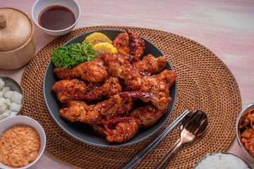 Gang Jeong chicken or crispy and tender Korean fried chicken smothered in a sticky, spicy red sauce Served with kimchi, dipping sauce, rice and sweet corn.