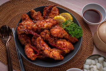 Gang Jeong chicken or crispy and tender Korean fried chicken smothered in a sticky, spicy red sauce Served with kimchi, dipping sauce, rice and sweet corn.
