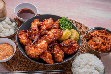 Gang Jeong chicken or crispy and tender Korean fried chicken smothered in a sticky, spicy red sauce Served with kimchi, dipping sauce, rice and sweet corn.