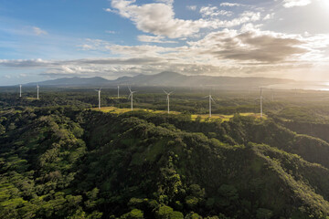 Aerial view of wind turbines on the mountains, electric power production on the seashore on Oahu Island, Hawaii