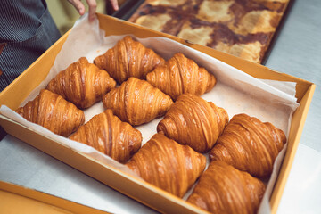 Fresh France plane croissant on bakery restaurant cafe coffee wooden table.restaurant bakery menu.dessert.bakery shop, baked croissant.Homemade croissants on bakery cafe.Dessert breakfast in France.