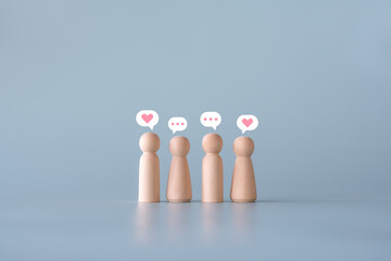 People and social media concept sending, receiving email talking to partner. Group of wooden human figures using wireless technology discussion.