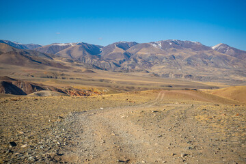 Road in Kyzyl-Chin valley or Mars valley with mountain background in Altai, Siberia, Russia.