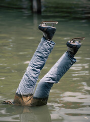 Dead ice skater head downwards in water out of season © Zsolt Biczó