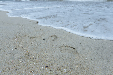 Summer holiday on the beach by the ocean. White sand, endless ocean, sky with clouds. A place for your best vacation