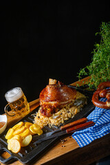 rustic pork knuckle with sauerkraut, sweet mustard and fried potatoes