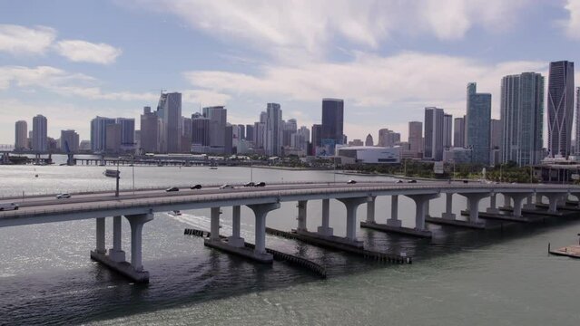 Aerial Forward Shot Of Cars Moving On Bridge Roads Over Sea By Modern City - Miami, Florida