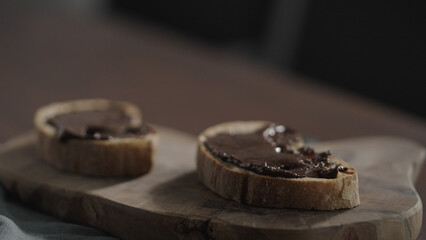 chocolate spread on ciabatta slice on olive board