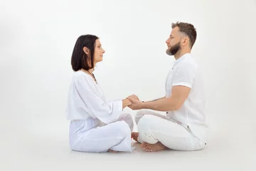 Foto op Plexiglas Man and woman, couple in love, wear white outfit, practice Pilates and yoga, sit in lotus pose. Conscious tantra love © Татьяна Волкова