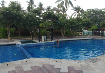 A woman at hotel's swimmping pool in Lovina, Bali, Indonesia.