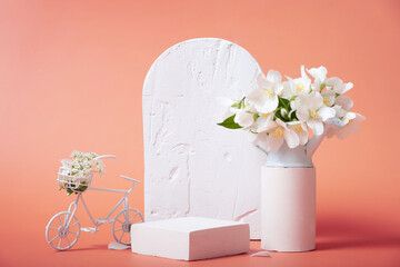 Natural beauty pedestal. Empty cosmetics podiums for product on pink background with jasmine flowers and decorative bike