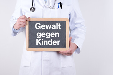 Arzt mit einer Tafel auf der Gewalt gegen Kinder steht