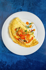 fresh omelet with vegetables on the white plate