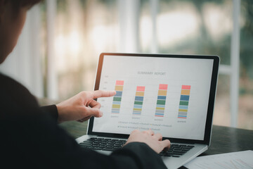 Business people point to charts and graphs that show results of success.