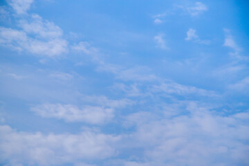 Blue sky with a few clouds background.