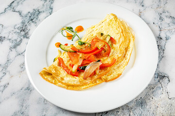 fresh omelet with vegetables on the white plate