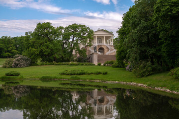 Fototapeta premium View of the Cameron Gallery on the shore of Large Pond in Catherine Park in Tsarskoye Selo on a sunny summer day, Pushkin, St. Petersburg, Russia
