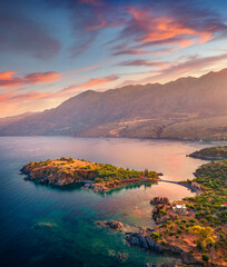 Exciting evening view from flying drone of Skopa Peninsula, Kotronas town location. Superb sunset on Mediterranean sea, Peloponnese peninsula, Greece, Europe. Traveling concept background..
