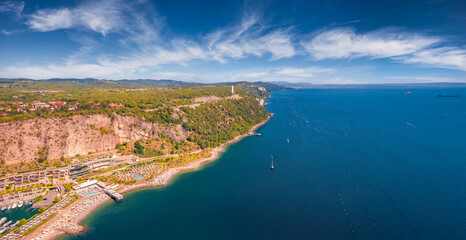 Panoramic summer view from flying drone of Marina di Portopiccolo town,Trieste location, Italy, Europe. Aerial morning scene of Portopiccolo Sistiana Beach. Vacation concept background.