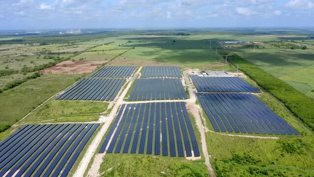 Aerial drone flyback pov of El Soco solar photovoltaic park of San Pedro De Macoris in Dominican Republic