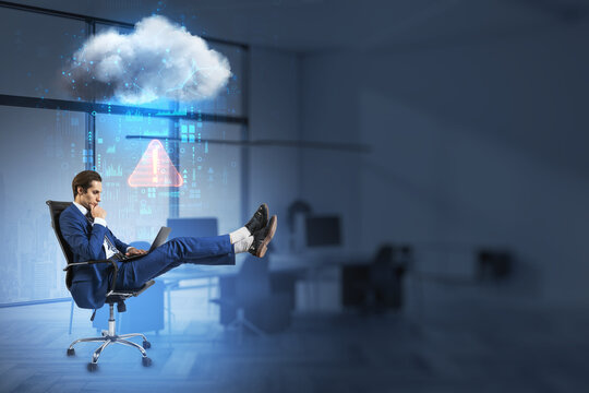 businessman with laptop relaxing in swivel-chair in blurry office interior with abstract hologram raining cloud and mock up place for your advertisement. 