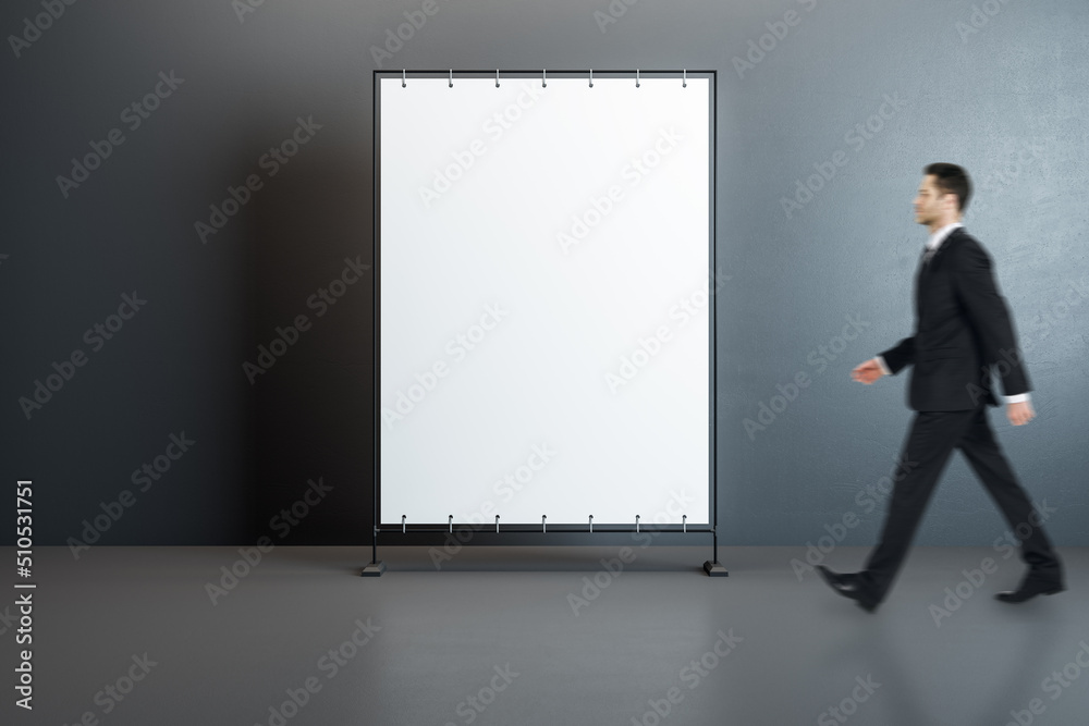 Poster front view on blank white poster with place for your text or logo and walking man in black suit on g