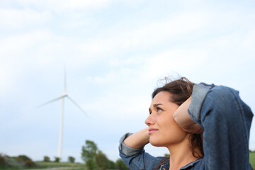 Annoyed woman suffering windmill noise in a wind farm