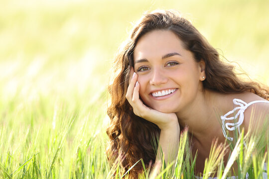 Happy woman with perfect smile in a wheat field