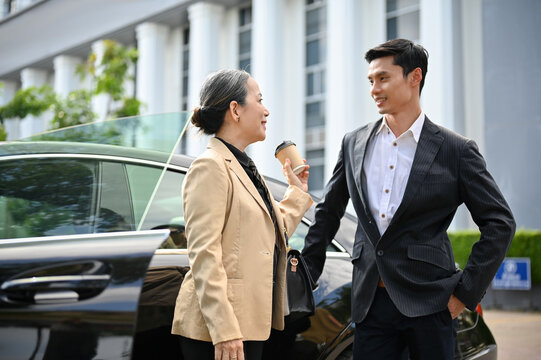 Successful Aged Asian Businesswoman And Professional Businessman Standing In Front The Car.