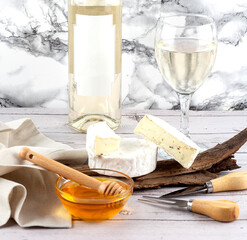White wine served with camembert cheese and honey