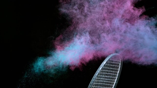 Super Slow Motion Shot of Hitting Badminton Shuttlecock Containing Neon Powder by Racket at 1000fps.