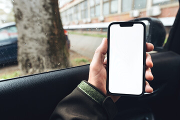 Smartphone mockup, car driver holding mobile phone with blank white screen