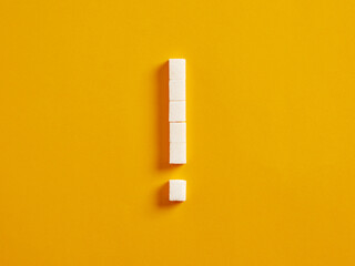 Exclamation mark made of sugar cubes. Overuse or abuse of sugar in nutrition or diet