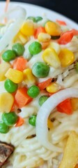 A colorful salad of carrots, green peas, corn and onions topped with a delicious sauce.