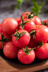 fresh cherry tomatoes in a plate on table