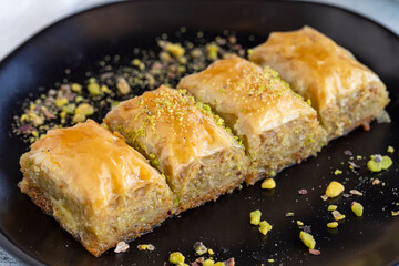 Pistachio baklava. Traditional Mediterranean cuisine delicacies. Baklava on stone background. Close-up. local name fistikli sarma baklava