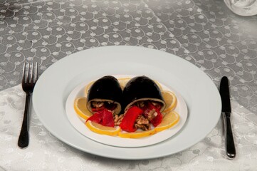 Two stuffed aubergines. Stuffed aubergines are made of walnuts and capia peppers.