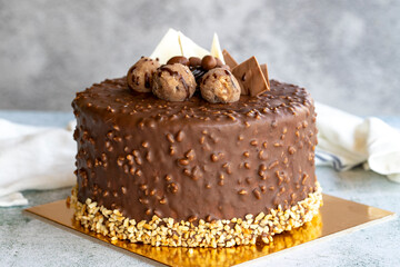 Cake with chocolate chips and profiteroles. Birthday or celebration cake. close up
