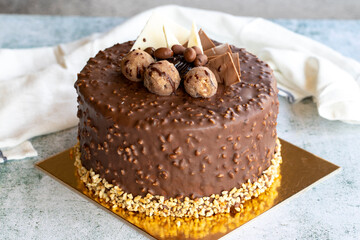 Cake with chocolate chips and profiteroles. Birthday or celebration cake. close up