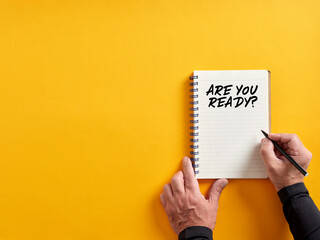 Male hand writing are you ready on a notepad. Are you ready concept.