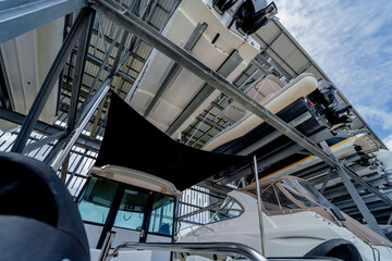 Speed motor boats are stapled in a garage system in the marina